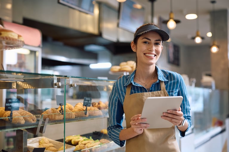 Happy female bakery owner at Pastel
