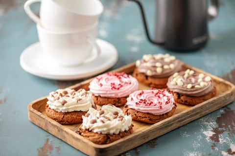 Thick gourmet cookies with chocolate and cream cheese topping