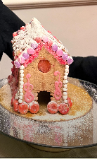 Gingerbread house cake decorated with flowers