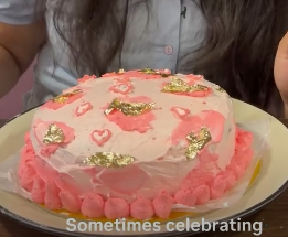 Pink floral celebration cake with gold leaf