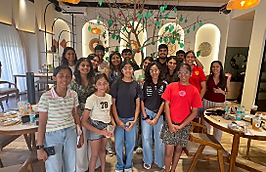 Pastel team and workshop participants smiling together indoors