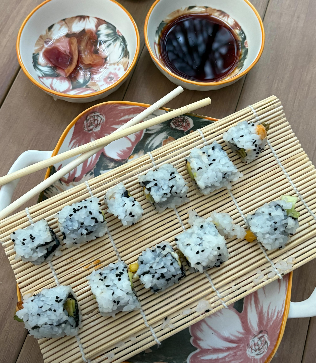 Plated sushi rolls with soy sauce