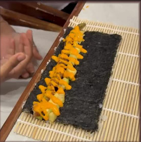 Hand-rolling sushi at a workshop